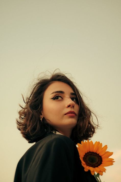 Portrait of a Woman with a Sunflower · Free Stock Photo Sunflower Portrait, Portrait Of A Woman, Clear Sky, Free Photos, Free Stock Photos, Stylish Women, Flower Power, Feathers, Portrait Photography