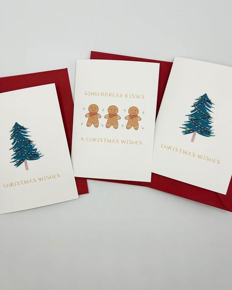 Photo of two newly designed Christmas cards by FrameYourWorldCo. On the left, ‘Cinnabob,’ featuring a whimsical cinnamon roll character in a festive setting. On the right, ‘Christmas Wishes,’ with a charming gingerbread man surrounded by stars and the corrected caption ‘Gingerbread Kisses and Christmas Wishes.’ The background is softly blurred to highlight the cards Cinnamon Roll Character, Craft Market, Sweet Messages, Christmas Card Design, Cinnamon Roll, Card Inspiration, Super Excited, Christmas Wishes, Gingerbread Man