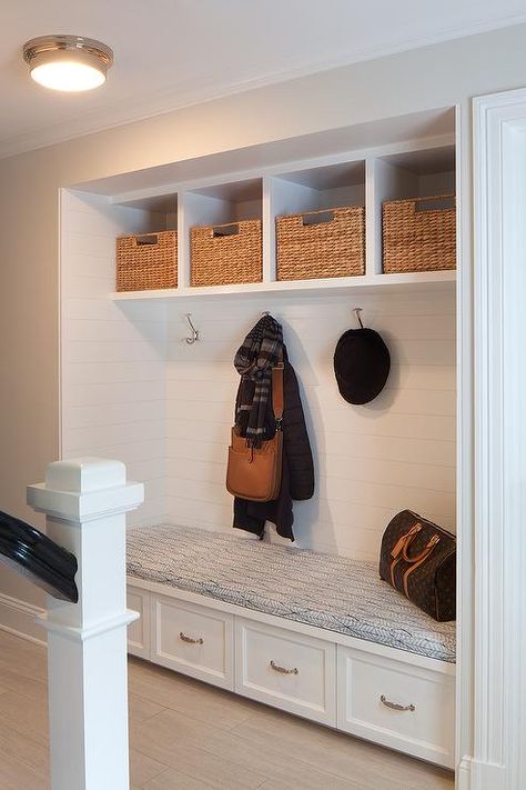 A recessed mudroom alcove is filled with a built-in bench fitted with four with drawers tucked four coat hooks lining a shiplap wall accented with overhead shelves filled with woven bins. Overhead Shelves, Alcove Storage, Foyer Bench, Mudroom Cubbies, Wall Shelf With Hooks, Recessed Shelves, Shelf With Hooks, Log Home Interiors, Room Bench