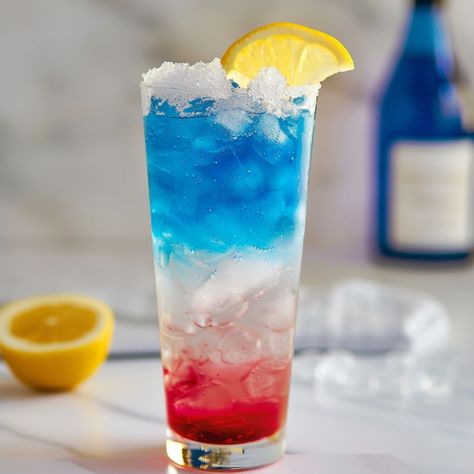 Layered Rocket Cocktail - Foodiosity Blue Colored Cocktails Drink Recipes, Rocket Pop Drink, Rocket Pop Alcoholic Drink, Blue Raspberry Mixed Drinks, Blue Curacao Mocktail Recipe, Mocktails Blue Curacao, Pop Drink, Rocket Pop, Hey Bartender