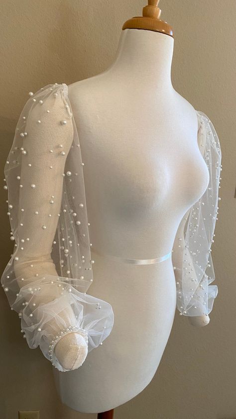 Pearl encrusted tulle detachable wedding sleeves Soft gathers at the shoulder  Gathered at the wrist into a pearl/bead trim Ties across back with pearl/bead detail *made to order  Measurements will be customized * density/spacing of pearls may differ due to fabrics available at time of order Pearl Sleeves, Bridal Topper, Wedding Sleeves, Bridal Sleeves, Wedding Dress Topper, Detachable Wedding Dress, Dress Topper, Pearl Wedding Dress, Wedding Shrug