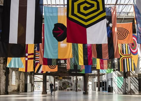 installation view: Archie Moore - United Neytions, 2014-2017 | The National: New Australian Art | at Carriageworks, Sydney Hanging Fabric Installation, Flag Installation, Flag Art Installation, Flag Signage Design, Fabric Installation Architecture, Protest Art Installation, Archie Moore, Hanging Flags, Interactive Exhibition