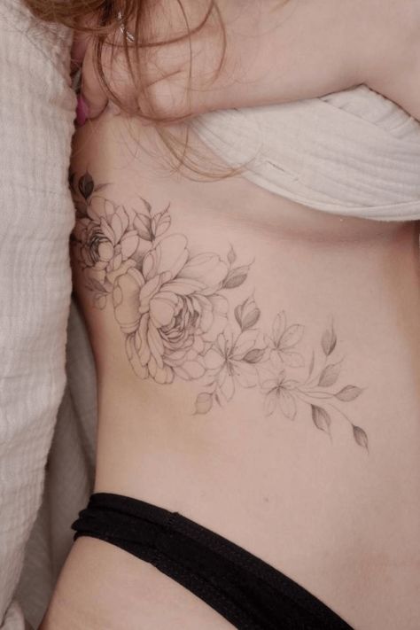 39 Peony Tattoo Design Ideas You Don't Want To Miss Peony Thigh Tattoos Women, Peony Tattoo Hip, Peony Vine Tattoo, Peony Rib Tattoo, Rose And Peony Tattoo, Delicate Peony Tattoo, Peony Thigh Tattoo, Peony And Hummingbird Tattoo, Tattoo Peonies