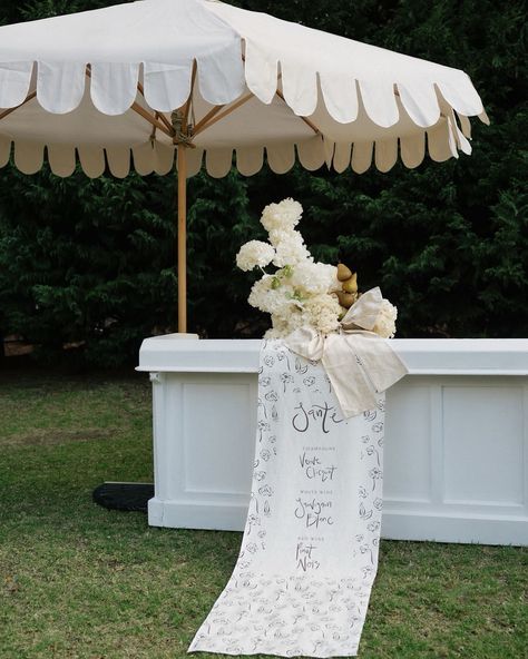 We worked with an incredible team to style an elevated garden party featured in The Anti-Bride featuring beautiful linen signage by TAWO STUDIO  Scalloped umbrellas, and gorgeous sculptural florals by Evebudblooms  Photo Australian Wedding Photographer - Stacey McLean   #wedding #weddinginspo #weddingbar #barsign #weddingsignage #fabricbarsign #adelaidewedding #melbournewedding #scallopedumbrella #gardensoiree #gardenwedding Elevated Garden Party, Martini Tower, Velvet Napkins, Neutral Wedding Inspiration, Signature Cocktails Wedding, Umbrella Decorations, Linen Tablecloths, Ruffle Linen, Umbrella Wedding