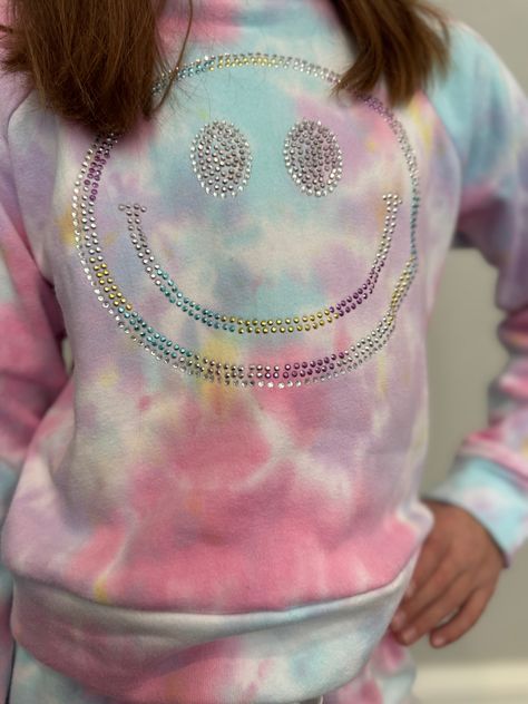 Brighten up your tween’s wardrobe with this Flowers by Zoe Pastel Tie-Dye Smiley Sweatshirt! Featuring a dreamy blend of pink, blue, and yellow tie-dye, this cozy sweatshirt is all about happy vibes. The standout feature? A dazzling rhinestone smiley face that adds just the right amount of sparkle! Made with ultra-soft fabric, it’s perfect for lounging in style or heading out with friends. Why You’ll Love It: ✨ Dazzling Rhinestone Smiley Design – Sparkly embellishments for a fun, trendy look.🎨 Smiley Sweatshirt, Smiley Design, Soft Color Palette, Yellow Tie, Pastel Tie Dye, Yellow Ties, Happy Vibes, Girl Sweatshirts, Cozy Sweatshirts