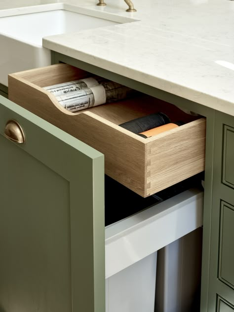 This hidden drawer above an integrated pull-out bin is great for storing bin liners, keeping your kitchen cupboards organised. Shaker cupboards painted in Farrow & Ball Green Smoke (No. 47). Bin Cupboard, Pull Out Bin, Hidden Drawer, Drawer Bins, Kitchen Sink Storage, London Kitchen, Kitchen Pulls, Cupboard Drawers, Shaker Cabinets