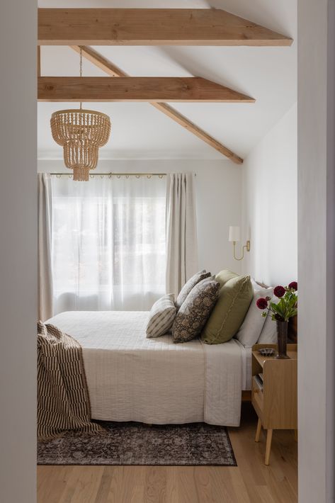 From garage to gorgeous ✨🚪 With a growing family in need of more space, this garage was transformed into a bright and cozy primary suite. The exposed wood beams in the vaulted ceiling add warmth and charm, making it the perfect retreat. 🛏️🌿  Design📐 @studio_vae Construction👷‍♂️ Jewell Baths Photography📷️ @nicolediannephoto Styling🌼@emilyairoso @shopleoleo Beams In Master Bed, Exposed Beams Bedroom, Exposed Wood Beams, Retreat Design, Bath Photography, Primary Suite, Exposed Beams, Exposed Wood, Growing Family