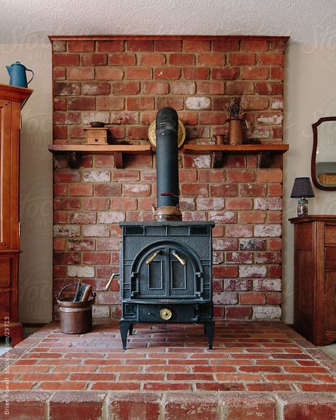 wood burning stove hearth ideas | old wood stove on brick hearth by Brian Powell - Stocksy United ... Wood Stove Surround, Stove Decor, Wood Stove Hearth, Paneling Ideas, Brick Hearth, Wood Stove Fireplace, Fireplace Hearth, Pellet Stove, Stove Fireplace