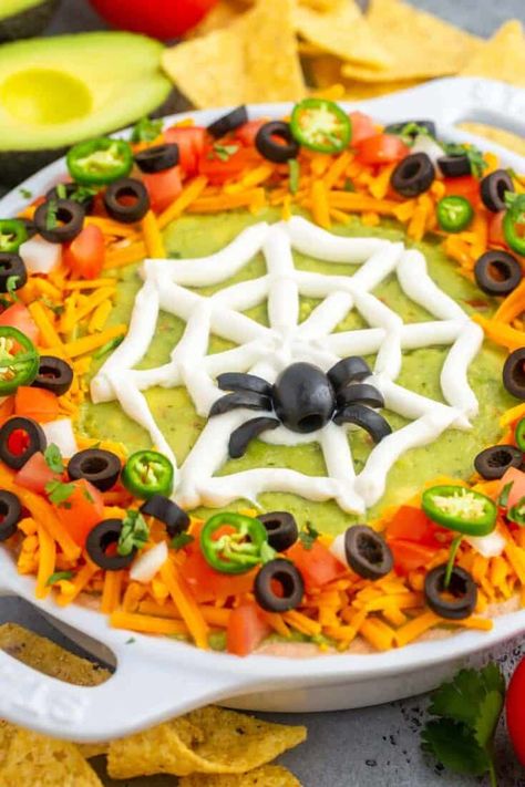 A delicious layered Halloween Taco Dip decorated with a fun spider web design is the perfect Halloween Party Food! This cold taco dip has layers of refried beans, seasoned cream cheese, and guacamole, and it’s easy to make, no cooking required. Spider Web Taco Dip Recipe, Spider Web Taco Dip, Halloween Dips, Spooky Brunch, Halloween Taco Dip, Halloween Boards, Halloween Apps, Halloween Bunco, Halloween Dip