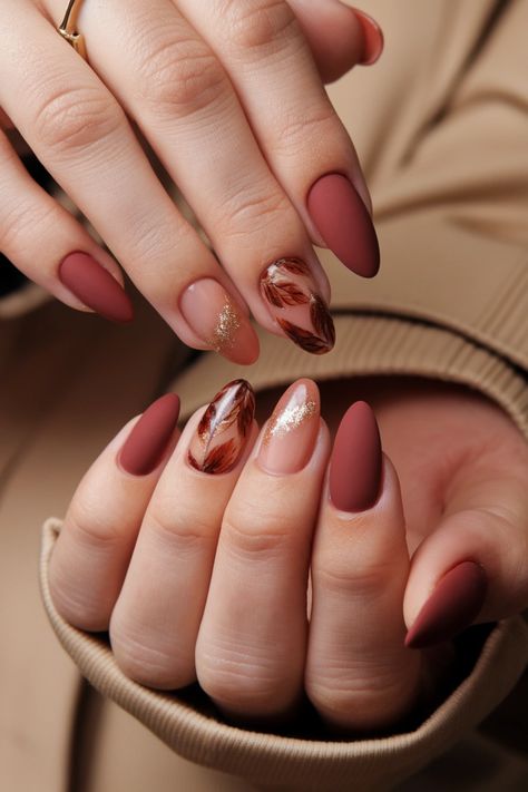 Embrace the beauty of autumn with stunning almond-shaped nails adorned in warm, earthy tones. These fall nail ideas feature rich burgundies, golden bronzes, and deep greens that perfectly capture the essence of the season. Elevate your style with intricate leaf designs or shimmering gold accents for a touch of elegance. Get inspired and create your unique autumnal manicure! #FallNailIdeas #AlmondNails #AutumnNails #NailArt #AutumnVibes Natural Almond Nails Fall, Almond Nails Fall, Natural Almond Nails, Fall Nail Ideas, Chic Autumn, Shaped Nails, Autumn Look, Leaf Designs, Almond Shaped