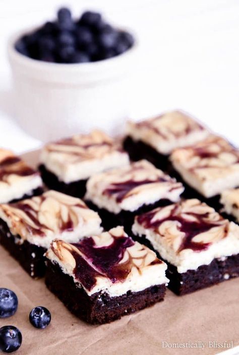 With a homemade creamy cheesecake, tangy fresh blueberries, & rich chocolate brownie these Blueberry Cheesecake Brownies are sure to be a hit at your next party! | blueberry brownies | Brownie cheesecake | dessert | summer party recipe | fresh blueberries | recipe | semi-homemade | easy sweet treat | swirled cheesecake | swirled brownies | summer fruit recipe | Brownie Slice, Raspberry Cheesecake Brownies, Blueberry Puree, Basic Chocolate Chip Cookies, Brownie Mix Recipes, Summer Fruit Recipes, Cheesecake Brownie, Chilled Desserts, Blueberry Cream Cheese