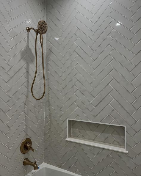 Loving this tile in a herringbone pattern 😍 Subway Herringbone Bathroom, Herringbone Bathtub Tile, Herringbone Tub Surround, Grey Herringbone Tile Bathroom, Herringbone Backsplash Bathroom, Harringbone Tile, Herringbone Bathroom Wall, Herringbone Shower Tile, Gray Herringbone Tile