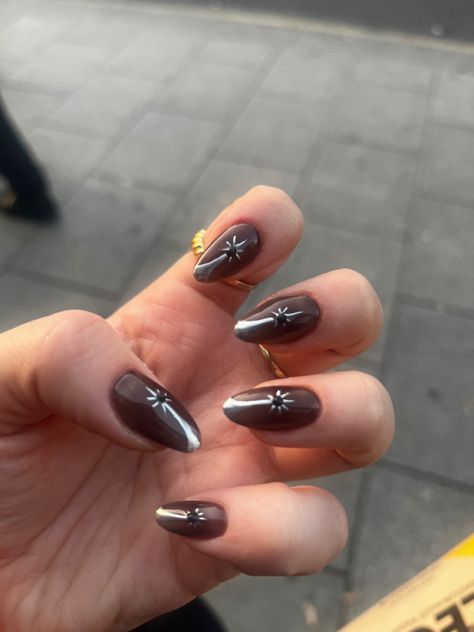 It’s a picture of brown nails with a silver star that’s placed in the middle. The tip of the star extends till the top of the nail forming a half french. A small black gem sits in the middle of the star. Brown Silver Nails, Brown And Silver Nails, Silver Nails, Brown Silver, Nail Art, Nails, Silver, Quick Saves, Art