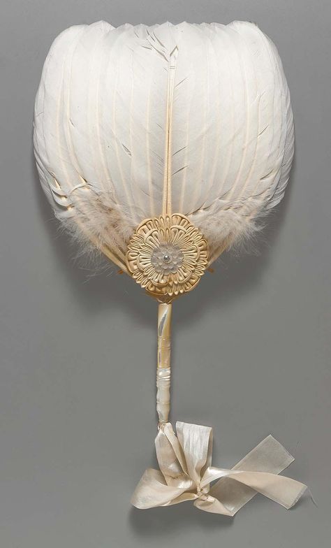 White feather fan with carved mother-of-pearl handle, white cloth rosette at base with shell blossom at center held in place with a metal grommet, white silk satin rib … Antique Fans, Feather Fan, Vintage Fans, Hand Held Fan, White Feathers, Chatelaine, Historical Fashion, Victorian Era, Hand Fan