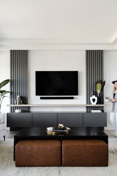 Hella Design Studio | Calgary Interior Design To give this TV wall some storage and style, we added grey slats to the wall on either side of the TV. A black floating media console and shelf top off the space. 📷: @heymjay Design Tv Wall, Tv Wall Panel, Tv Wall Ideas, Ruang Tv, Black Feature Wall, Feature Wall Living Room, Floor Renovation, Design Tv, Interior Design Per La Casa