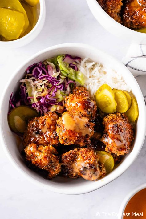 These hot honey chicken bowls are as good as it gets! The crispy chicken contrasts wonderfully with a bowl of rice, coleslaw, sweet pickles, and a drizzle of spicy mayo. #theendlessmeal #chicken Hot Honey Chicken, Honey Chicken Recipe, Bowl Of Rice, Crunchy Chicken, Chicken Bowl Recipe, Chicken Bowls, Spicy Mayo, Hot Honey, Bowl Food