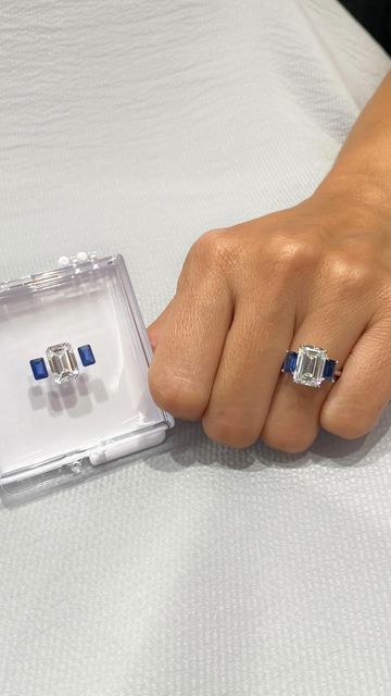 Lauren B on Instagram: "In love with this three-stone ring 😍 it features a 3.88ct emerald lab diamond center-stone & is flanked by matching emerald cut blue sapphires. Watch along to see how it’s made - style LR-300. #howitsmade #laurenbjewelry #emeraldring #threestonering #sapphirering" Lauren B Jewelry Engagement Rings, Emerald Stone Rings, Sapphire Side Stones, Blue Diamond Engagement Ring, Bezel Set Engagement Ring, Sapphire Wedding Band, Cute Engagement Rings, Future Engagement Rings, Emerald Cut Rings