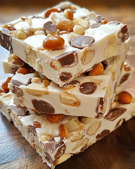 Homemade Nougat Bars: Ingredients: - 1 cup granulated sugar - 1/2 cup light corn syrup - 1/4 cup water - 2 large egg whites - 1/4 teaspoon cream of tartar - 1/2 cup chopped nuts (e.g., almonds, peanuts, or cashews) - 1 cup mini marshmallows - 1 teaspoon vanilla extract For the Chocolate Coating: - 1 1/2 cups semisweet chocolate chips - 2 tablespoons vegetable oil or coconut oil Instructions: 1. Line an 8x8-inch baking pan with parchment paper, leaving some overhang for easy rem... Homemade Nougat, Nougat Bars, Eat Me Drink Me, Decadent Food, Chocolate Coating, Baking Pan, Mini Marshmallows, Cream Of Tartar, Cute Desserts