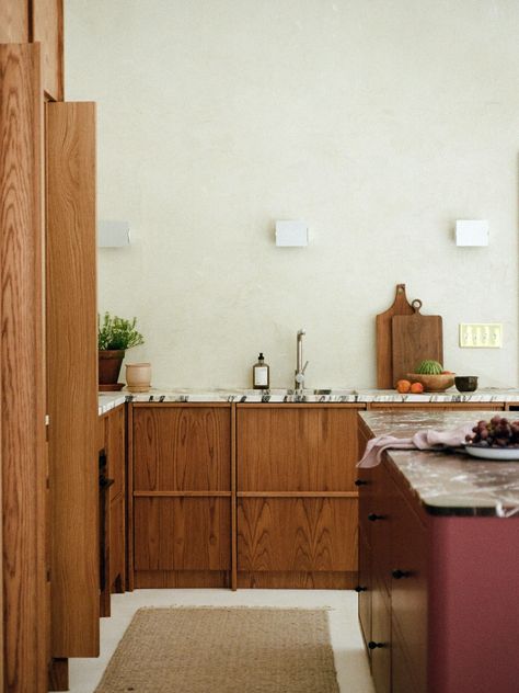 This two-tone kitchen features wood cabinets and a dreamy maroon island. But before the kitchen remodel took place? It was entirely bland. Click the pin to see the before and after transformation. Moody Kitchen, Disc Interiors, Dining Banquette, Classic Kitchen Design, Cabin Kitchen, Blue Granite, Weekend House, Cabin Kitchens, Modern Kitchen Cabinets