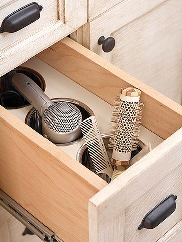 Customize Cabinets:  Here a deep drawer can safely hold a hot flat iron and other primping tools after use. Custom-fit stainless-steel canisters allow these beauty tools to cool safely inside the drawer as well as house brushes, combs, and a hair dryer. Need to do this in my daughters bathrooms! Curling Iron Storage, Diy Bathroom Storage Ideas, Diy Bathroom Design, Bathroom Drawers, Diy Bathroom Storage, Vanity Drawers, Creative Storage Solutions, Vinyl Decor, Creative Storage