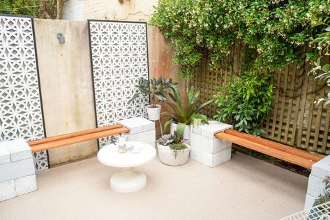 The best way to cover up unsightly walls and fences is with large-scale outdoor screens, says Dan. “We chose these decorative breeze brick-look screens which instantly created Palm Springs vibes in this tired courtyard.”  “If you have a larger space to work with, you could also anchor the screens at the base with besser blocks and use them to separate the outdoor area and create different zones for reading, dining and more,” says Dan. Outdoor Hacks, Cinder Block Walls, Easy Diy Hacks, Outdoor Screens, Small Courtyards, House Deck, Rental Decorating, The Courtyard, Wall Garden