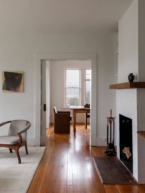 Neutral living room with fireplace in jewelry designer Kathleen Whitaker's Echo Park, Los Angeles, home. The white paint colors are Martha Stewart's Lamb and Popcorn. #remodelista #remodel #hometour #losangeles #interiordesign #homeinspo #white #neutral #livingroom Neutral Living Room With Fireplace, Echo Park Los Angeles, White Brick Fireplace, Room With Fireplace, Interior Remodel, White Paint Colors, Neutral Living Room, Modern Houses Interior, Echo Park