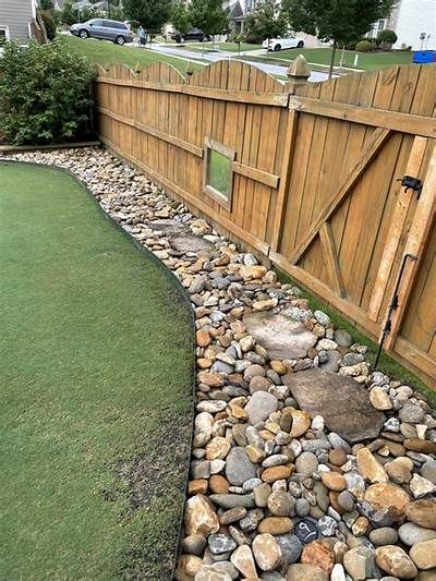 Rock border along fence line - Rock Border Along Fence, Fence Edge Landscaping, Fence Border Landscaping, Rock Drainage, Fence Gardening, Border Landscaping, Fence Edging, Backyard Aesthetic, Fence Border