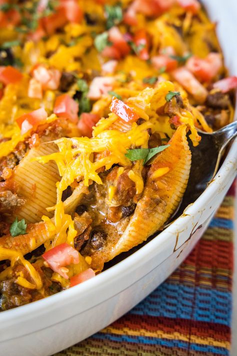 Cheesy taco stuffed shells are an easy Tex-Mex dinner made from jumbo pasta shells filled with creamy taco beef, salsa, and melty cheese. Mexican Shells And Ground Beef, Taco Noodle Bake Stuffed Shells, Mexican Pasta Shells With Ground Beef, Tex Mex Stuffed Shells, Taco Pasta Shells Ground Beef, Mexican Stuffed Shells, Roasted Corn Salsa, Taco Stuffed Peppers, Homemade Salsa Verde