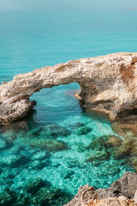 Ayia Napa is a place where you can find the most beautiful crystal clear blue waters, stunning cliff formations and so much more. Explore the Love Bridge, sea caves, Cape Greco, chapel Agioi Anargyroi, Konnos Beach, and the Open Sculpture Park. | Things to do in Cyprus | Best places to visit in Cyprus | Cyprus bucket list | Cyprus places to visit | Cyprus travel | Cyprus travel guide | What to do in Cyprus | #cyprus #travel #ayianapa #travelguide #thingstodoincyprus #visitcyprus Love Bridge Cyprus, Sea Caves Cyprus, Cape Greco Cyprus, Aya Napa Cyprus, Cyprus Photography, Best Places In Cyprus, Cyprus Aesthetic, Cyprus Beaches, Ayia Napa Cyprus