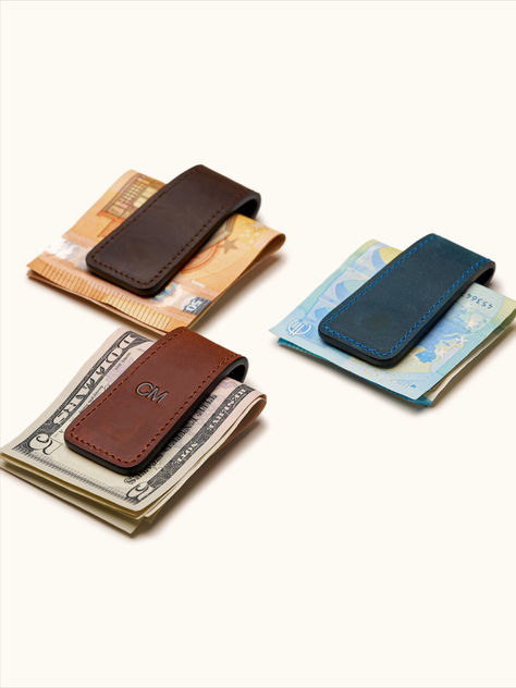 Meet your new favorite accessory: our magnetic money clip. Wrapped in luxurious leather and equipped with powerful magnets, it holds up to 20 folded bills. Perfect for days when you want to carry just the essentials. Made from durable top grain leather, it offers free embossing for personalization. Ideal for weddings, groomsmen, or minimalist enthusiasts. Fits easily in your pocket, blending practicality with style. Bookmark Pen, Wallet Storage, Leather Bookmark, Macbook Sleeve, Camera Straps, Clip Wallet, Groomsmen Gifts, Modern Gentleman, Money Clip Wallet