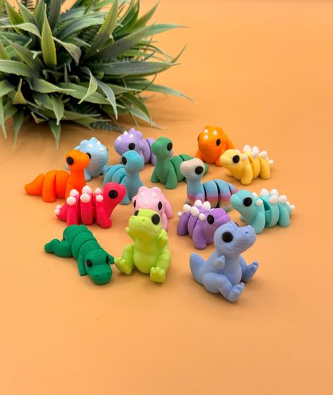 This random bundle of cute 3D printed dinosaurs toys includes miniature Triceratops, Brachiosaurus, Stegosaurus, and T-Rex. The 3D printed dinos come in a variety of colors, including pink, purple, orange, blue, dark green, mint green, yellow, and rainbow. We are constantly adding new models to our shop, so your order may include new dinosaurs or color variations not in this listing.  *Custom Order Please contact us for custom requests for any of our listings.  Authorized Seller for designs by Z 3d Printing Ideas Cute, Cute 3d Printing Ideas, 3d Print Ideas, Dinosaurs Toys, Cool 3d Prints, 3d Printing Ideas, Dinosaur Craft, 3d Printing Toys, Useful 3d Prints