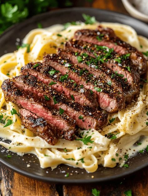 Prepare your taste buds for an unforgettable culinary experience with this Spicy Cajun Steak with Creamy Alfredo Pasta recipe! This dish combines the bold flavors of Cajun seasonings with the rich, creamy texture of Alfredo pasta. If you’re in the mood for something truly special, look no further. Whether you're cooking for a romantic dinner or a vibrant gathering, this meal promises to impress and delight. Cajun Steak Pasta Recipes, What Goes With Steak Dinners, Steak Tips Pasta Recipe, Garlic Parm Steak Pasta, Flank Steak Pasta Recipes, Cajun Beef Pasta, Steak Linguine Pasta, Garlic Parmesan Steak Pasta, Steak And Alfredo Pasta