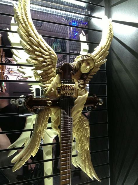 Enlarge to see details amid mirror reflections background. ESP custom guitar with cross and thoughtful angel with large wings at the headstock. RESEARCH #DdO:) - https://www.pinterest.com/DianaDeeOsborne/instruments-for-joy/ - INSTRUMENTS FOR JOY. Shown at NAMM 2013 ESP Guitars Showroom Custom Shop. 6-String electric: T. Takamizawa from The Alfees. NOTE: Strung for left handed guitarist. Pinned via Neville Watts. Angle Guitar, Eletric Gutair, Electric Guitar Collection, Angel Guitar, Angel Wing Guitar, Angel Electric Guitar, Customized Guitar, Electric Guitar Unique, Left Handed Electric Guitars