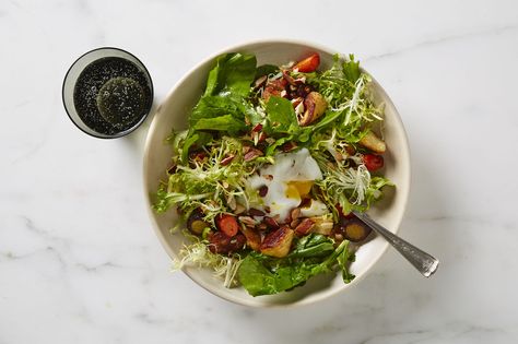 This salad was inspired by the classic French bistro salad, in which sturdy winter greens are laced with crisp lardons of bacon and a silky poached egg. We’ll never begrudge you a bit of bacon, but here vegetables are roasted to give the salad a leaner form of texture, flavor, and color. French Bistro Salad, Bistro Salad, Easy French Recipes, Warm Salad, Hearty Salads, Week Diet, Poached Egg, French Bistro, Roasted Veggies