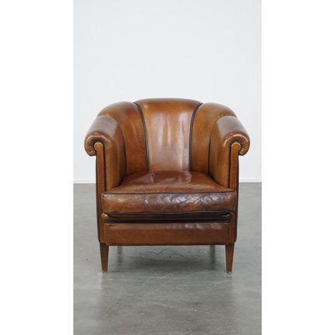 Unique vintage cognac-colored leather club chair with good seating comfort and a finish with black piping. This incredibly beautiful, cognac-colored cowhide club chair is a true eye-catcher that will feel at home in almost any interior. This club chair is finished with black piping and has a special backrest. It is equipped with a loose seat cushion and has good seating comfort. It has suffered signs of wear through years of use, but it is structurally in good condition and can of course be used Leather Club Chairs, Club Chair, Colored Leather, Club Chairs, Seat Cushion, Cognac, Unique Vintage, Seat Cushions, Cushions