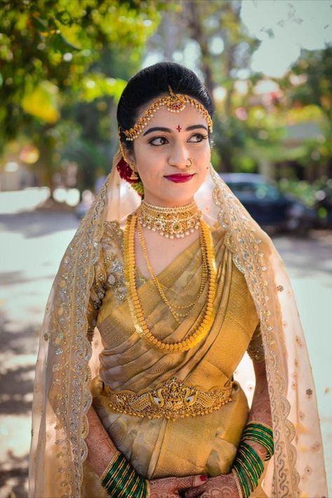 South Indian bride in a gold kanjeevaram with a head dupatta Gold Kanjeevaram Saree, Indian Bridal Veil, Yellow Wedding Saree, Veil Shots, South Indian Bride Saree, Indian Bride Poses, Golden Saree, Indian Wedding Poses, Bridal Sarees South Indian