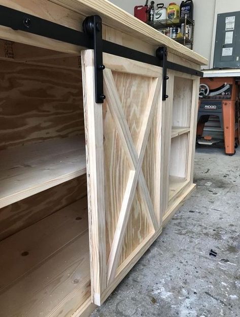 The first thing I did was build two frames out of the 2x3's. And then added the side panels to the sides, using plywood. Then I glued and nailed down the face frame boards.Then I laid down the bottom shelf boards on the bottom frame. #diy #buildit #mediac Console Diy, Barn Door Console, Diy Sliding Door, Diy Sliding Barn Door, Diy Tv, Diy Barn Door, Sliding Barn Door, Media Center, Center Console