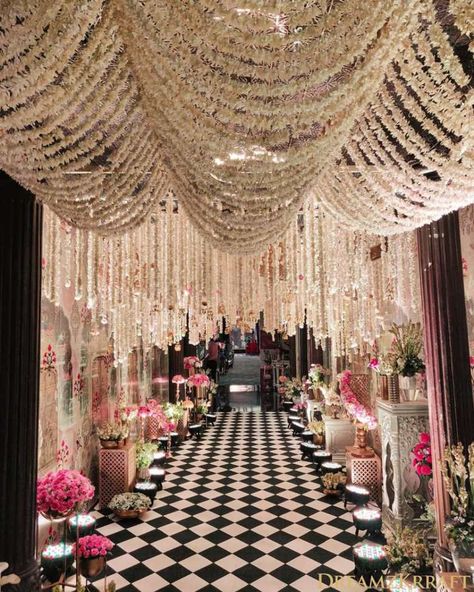 This Walkway with white Floral ceiling is so Wonderful and Chic Décor by Dreamkrraft Weddings - Mumbai.#tuberosedecor #tuberosetabletop #tuberoseweddingmandap #tuberosechandelier  #Tuberosehangings  #tuberosecanopy  #tuberoseflorlwall #weddingmandap  #walkwaywithTuberose #tuberoseentrance #tuberosedecoration  #tuberoseceiling #tuberosefloraldecor # tuberosebackdrop #tuberosebouquet #tuberoseweddingdecor #tuberosemandapdecor Wedding Walkway, Wedding Hall Decorations, Wedding Entrance Decor, Wedding Stage Design, Desi Wedding Decor, Mandap Decor, Dream Wedding Decorations, Luxury Wedding Decor, Wedding Planning Decor