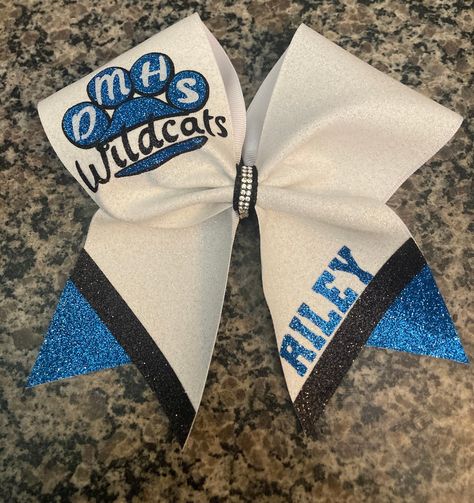 Custom cheer bow done in full glitter or regular grosgrain. Paw print on upper loop with school initials and mascot. Lower tail has one text. Bow is done in your custom colors and any text upper.  Lower right tail can have any text/number Bow is fully customizable and can be changed if needed. Bow comes standard on hair tie. measures approx 7x7 Cheer Bow Ideas, Wildcats Cheer, High School Design, Competition Cheer, Custom Cheer Bows, Glitter Cheer Bow, School Cheer, Cheer Ideas, Business Vision