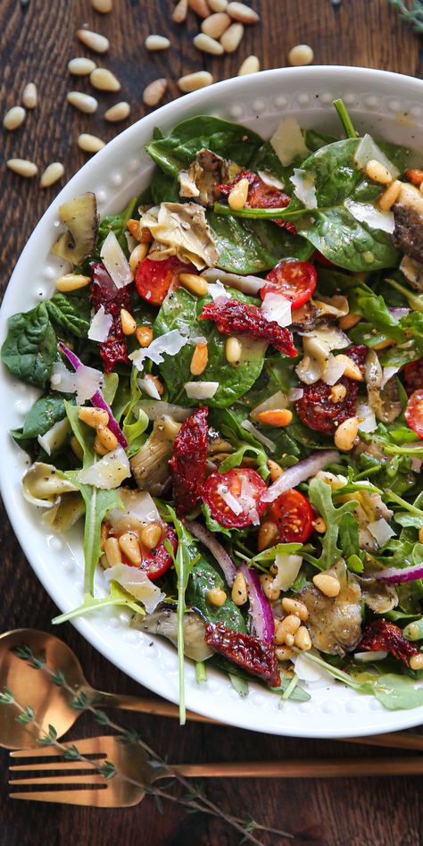 Italian Salad with Spinach, Arugula, Sun-Dried Tomatoes, Artichokes, Tomatoes, Pine Nuts, Parmesan - in a white bowl. Italian Arugula Salad, Salad Sun Dried Tomatoes, Sundried Tomato Salad, Italian Food Party, Pine Nuts Salad, Salad With Spinach, Spanish Summer, Homemade Italian Dressing, 2023 Recipes