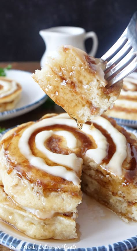 A white plate with a stack of cinnamon roll pancakes on it, with a bite being held up on a fork. Cinnamon Roll Pancakes Easy, Cinnamon Swirl Pancakes, Cinnamon Roll Pancakes Recipe, Cinnamon Pancakes Recipe, Fluffiest Cinnamon Rolls, Fluffy Buttermilk Pancakes, Yummy Pancake Recipe, Cinnamon Roll Icing, Cinnamon Filling