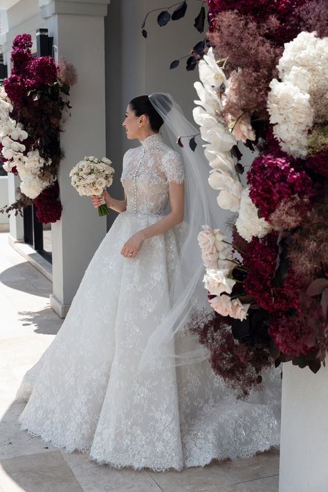 Helena radiates in custom couture STEVEN KHALIL. Captured beautifully by @georgejohnphotography. ⁣⁣ #stevenkhalil #stevenkhalilbride | Instagram Catholic Wedding Dresses, High Neck Lace Wedding Dress, Bouquet For Bride, Fake Roses, Flowers Wedding Bouquet, Steven Khalil, Rose Floral Arrangements, Party Table Centerpieces, Short Sleeve Wedding Dress