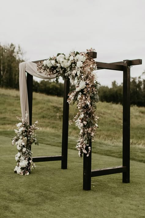 Garden roses, ranunculus, and other varieties of dahlia and tea roses were used to bring softness and contrast from the darker centres of the anemone. #wedding #weddingideas #weddingphotographer #weddingphotography #intimatewedding #weddinginspiration #weddingdetails #weddingflowers #flowers #elegantwedding #elegantweddingceremony #weddingceremony #blackweddingceremony #blackwedidngdecor #modernrusticweddingceremony #modernrusticweddingideas Black Wedding Arch, Black And Champagne Wedding, Black Ceremony, White Wedding Arch, Wedding Arches Outdoors, Wedding Arbors, Black And White Wedding Theme, Wedding Alters, Rustic Modern Wedding