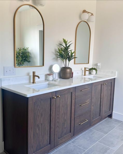 Happy Saturday stills folks. Once again we are bringing back good old still photos. Today I’m sharing our primary bathroom. I can’t wait to add some character to this room. I’m day dreaming about beams, dressing the window up with flowy curtains and hanging some pretty art or prints. All in time! For now enjoy our blank slate! #primarybathroom #bathroomdesigns #walkinshower Bathroom Dark Wood, Master Bath Dark Cabinets, Dark Brown Cabinets Bathroom, Natural Wood Bathroom Vanity With Dark Counter, Dark Wood Bathroom Vanity, Dark Wood Bathroom Cabinets Master Bath, Dark Wood Vanity Bathroom, Dark Brown Cabinet Bathroom, Dark Brown Bathroom Cabinets Gold Hardware