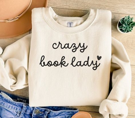 ABOUT OUR Crazy Book Lady Sweatshirt, Book Club Sweatshirt, Book Club Crewneck, Book Club Tee, Book Lover Shirt, Bookish Shirt, Bookish Sweatshirt, Book Lover Gift Sweatshirt: PRODUCTION TIME: 1-3 business days (Usually 2 business days) SHIPPING TIME: 2-5 business days (Usually 3 business days) PRODUCT DESCRIPTION: Gildan 18000 Sweatshirt Super soft cotton and excellent quality print makes. 50% Soft cotton (fibre content may vary for different colors) 50% Polyester  Light fabric (4.2 oz/yd² (142 Book Lover Aesthetic Outfits, Bookish Tshirt, Bookish Shirts, Bookish Outfits, Book Nerd Shirts, Book Clothes, Book Tshirts, Club Sweatshirts, Reading Shirts