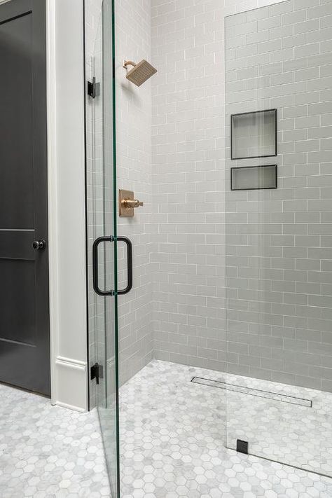 Marble hexagon floor tiles continue into a curbless floor-level shower boasting a frameless glass door and partition fitted with an oil rubbed bronze door handle. Zero Entry Shower Floor Tile, Master Shower Glass Enclosure, Master Bath Curbless Shower Ideas, Zero Entry Shower Ideas Tile, Seamless Walk In Shower Ideas, Curbless Shower Design, Zero Entry Shower Ideas Small Bathroom, Curb Shower Ideas, Curb Less Shower Ideas