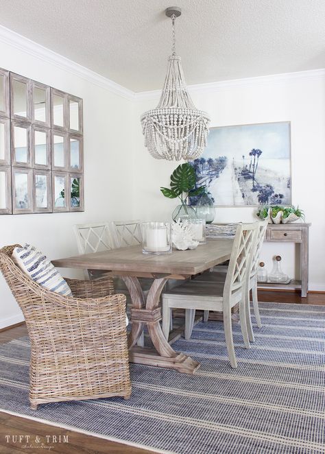 Coastal Boho Blues Home Design. See full tour at tuftandtrim.com! Dining Chairs Coastal, Dining Room Coastal Decor, Transitional Coastal Dining Room, Blue Coastal Dining Room, Beach House With Dark Wood Floors, Coastal Dining Table Centerpiece Ideas, Cozy Coastal Dining Room, Modern Coastal Interior Design Living Room, Small Coastal Dining Room