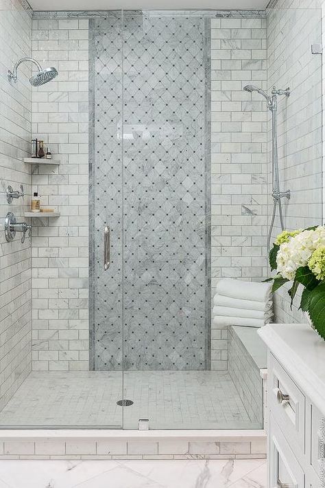 This walk-in shower benefits from the addition of a marble bench shower seat designed with floor to ceiling gray diamond accent tiles and stacked grid tiles. Shower Head Placement, Shower Accent Tile, Marble Bench, Shower Renovation, Accent Tiles, Custom Tile Shower, Bathroom Shower Faucets, Bathroom Shower Design, Master Shower