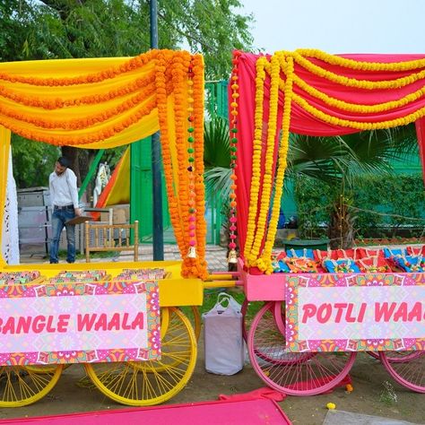 Indian Wedding Giveaways, Carnival Wedding Theme, Haldi Decoration Ideas, Stall Decorations, Sangeet Decor, Wedding Games For Guests, Indian Wedding Decor, Wedding Entrance Decor, Creative Wedding Gifts