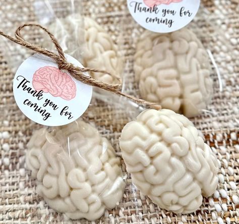 With each order, you receive the most elegant brain shaped soaps, a must-have for all!❤️ These are hand soaps.  Each soap comes individually packed in its own clear bag, and each bag has a custom tag attached on it. The soaps come in just as pictured, ready to be gifted! So you can see the joy on others' face right away!😊 The soaps are hand-made by us, my twin girls and I, at our small studio in NJ 🌟🎈 If you want a different custom tag design than the one shown, please let me know and I will Brain Themed Food, Medical Themed Halloween Party, Medical Themed Food, Medical Food Theme, Medical Party Favors, Brain Shape, Science Food, Doctor Party, Surgeon Doctor